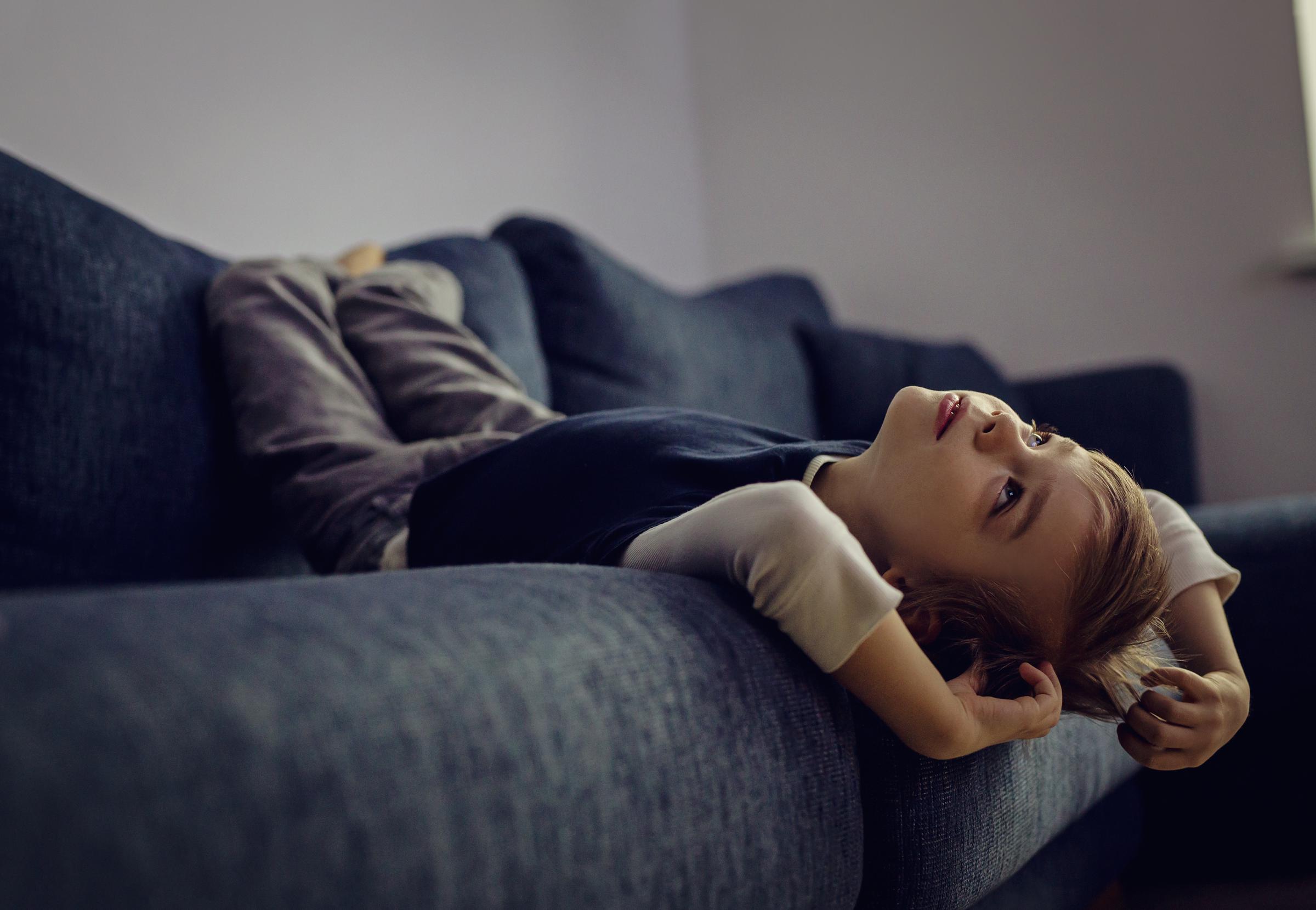 A boy laying on a sofa | Source: Getty Images