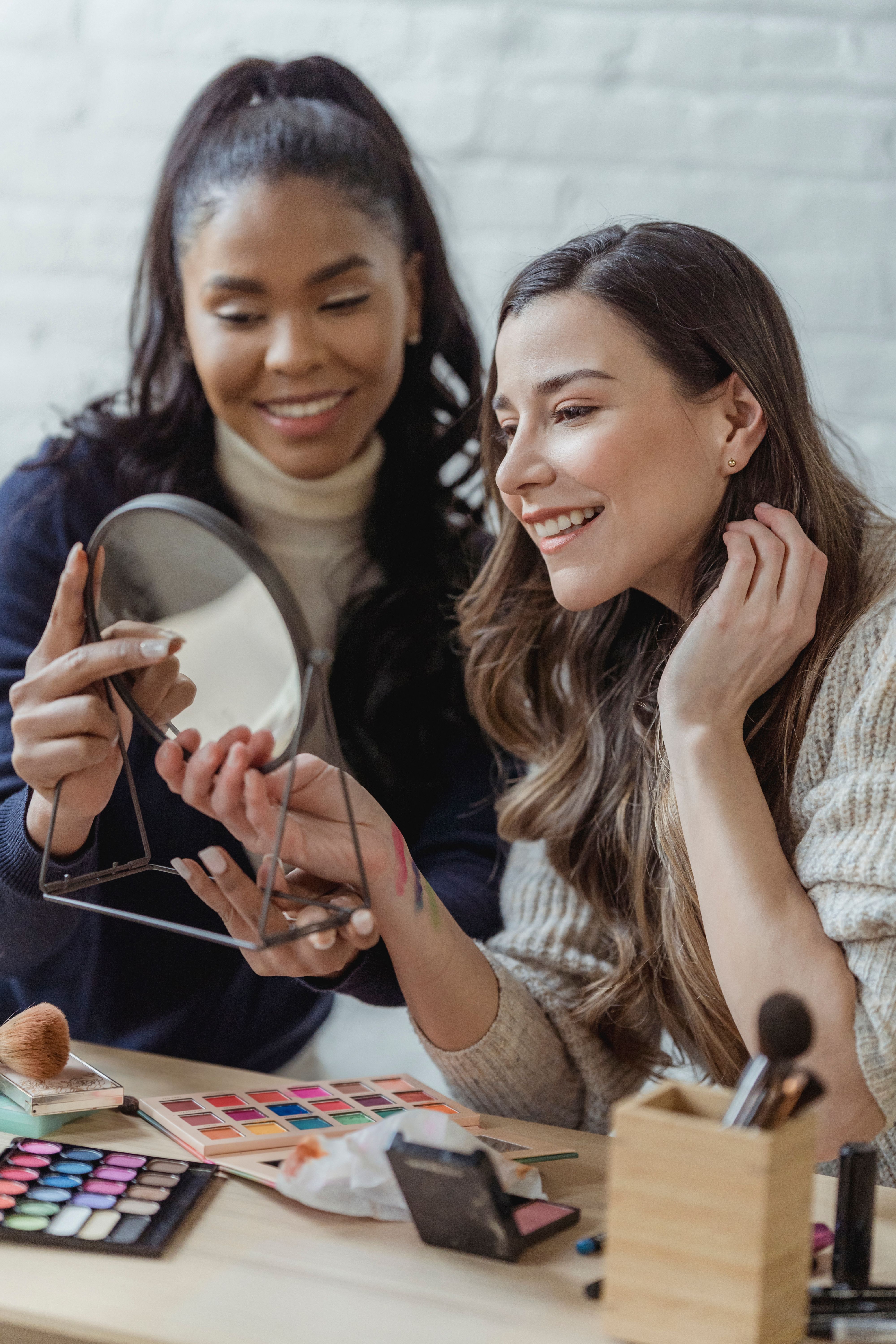 Two women during a share makeup session | Source: Pexels