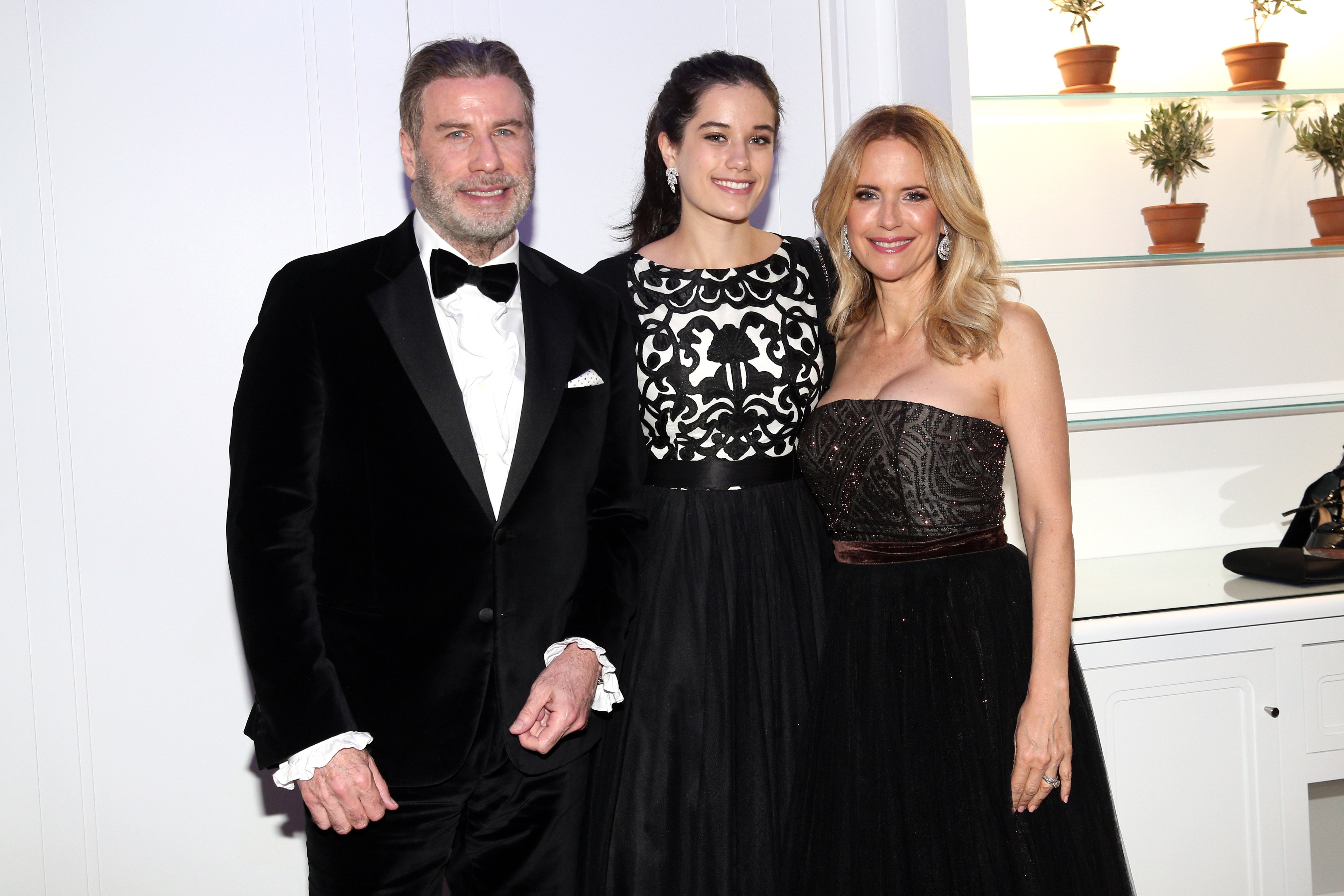 Ella Bleu Travolta poses with her parents, John Travolta and Kelly Preston, in a family portrait that highlights the close bond behind her journey into the entertainment world. | Source: Getty Images