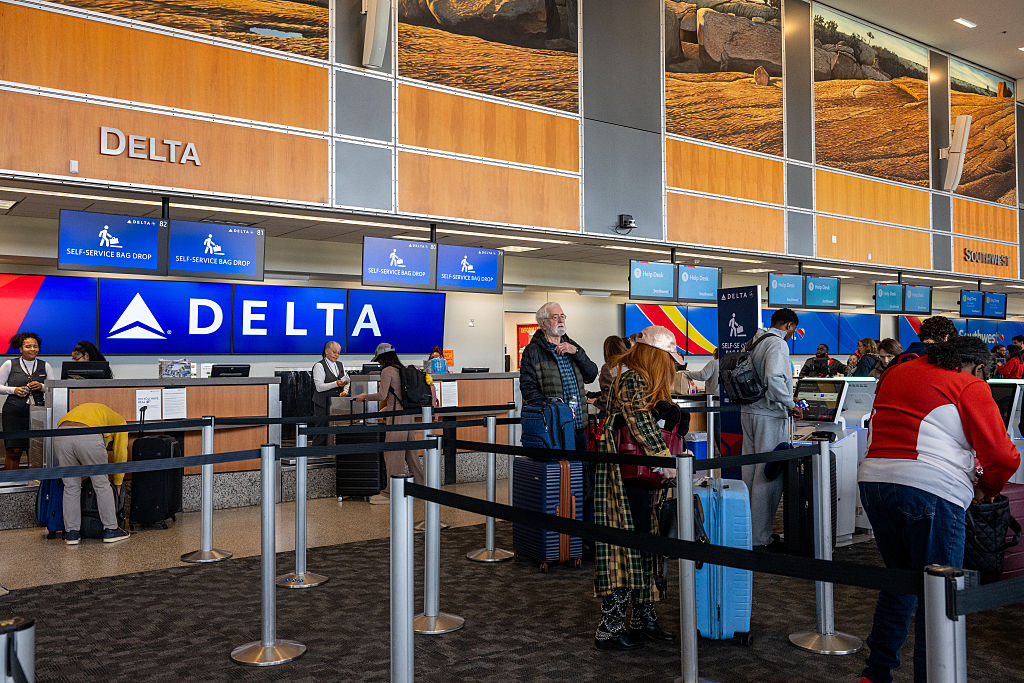 Travelers in line at the Delta Airlines check-in counter at the Austin-Bergstrom International Airport on January 12, 2026 in Austin, Texas | Source: Getty Images