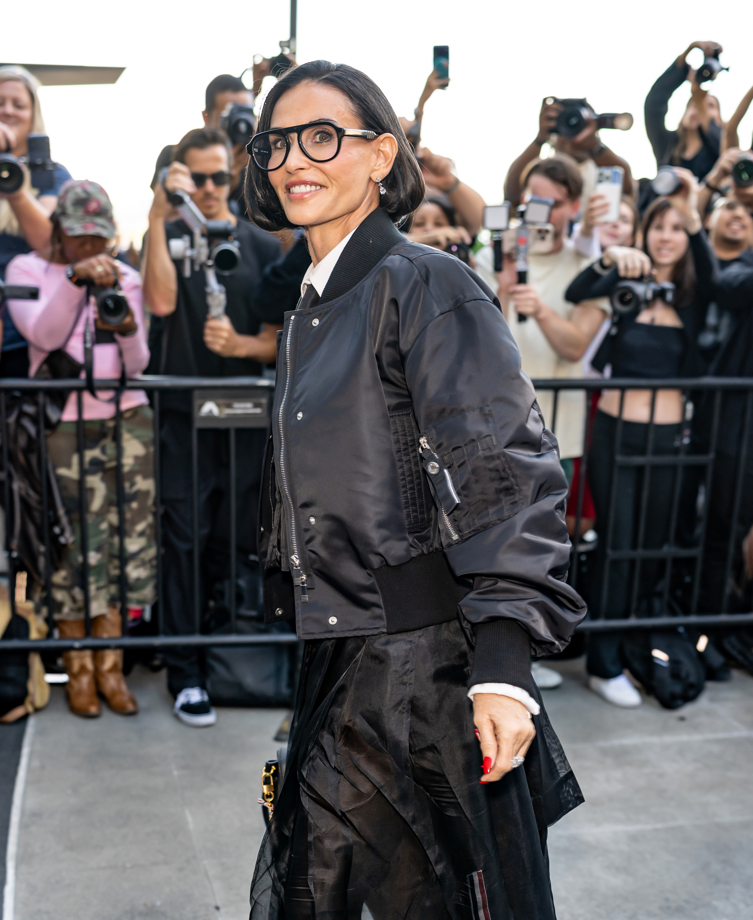 Demi Moore steps out at the Thom Browne Spring/Summer 2027 show during New York Fashion Week on September 15, 2026, wearing a chin-grazing dark bob, thick-rimmed glasses, and an all-black ensemble. | Source: Getty Images
