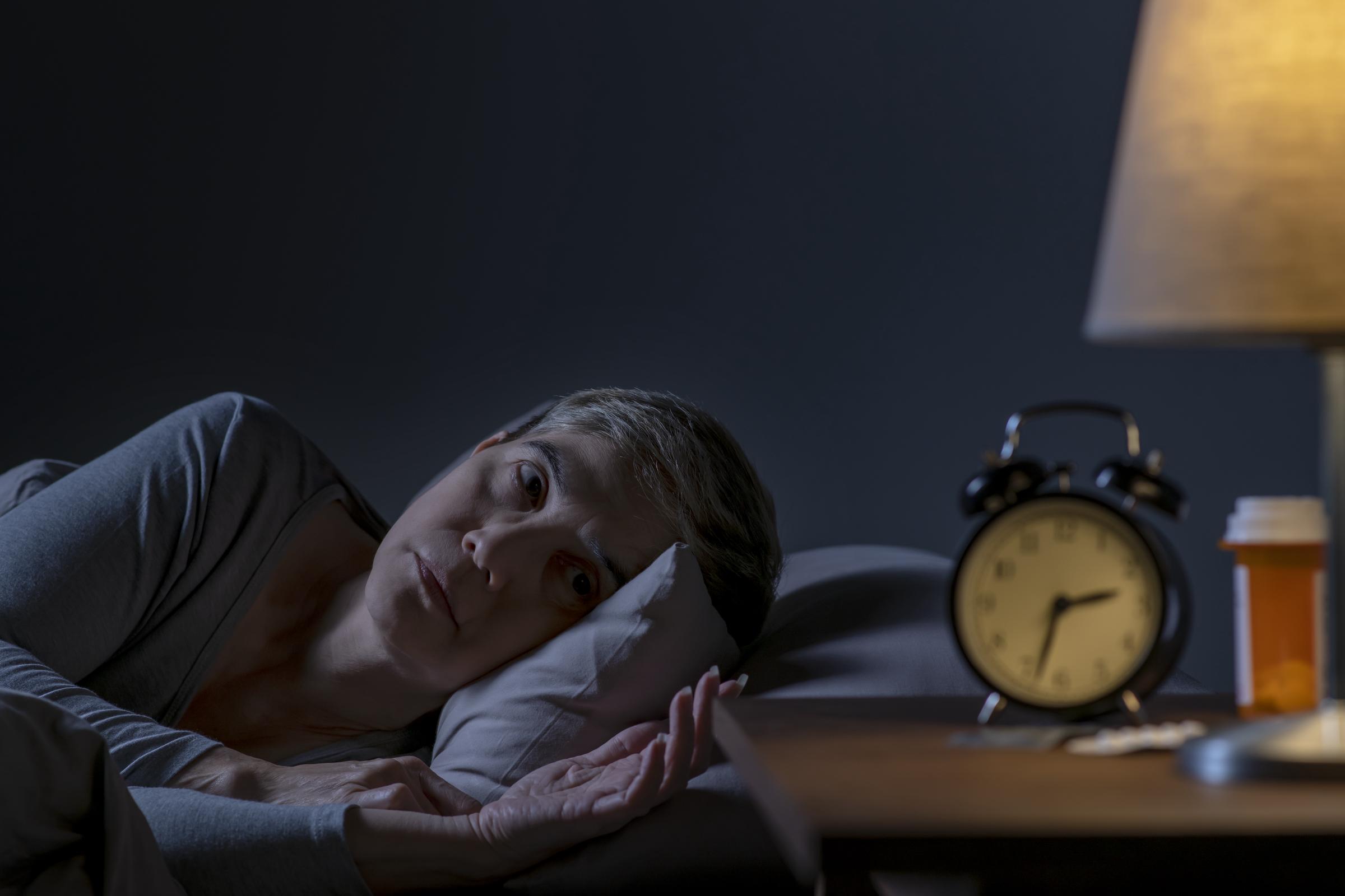 An older woman awake at night in her bed | Source: Getty Images