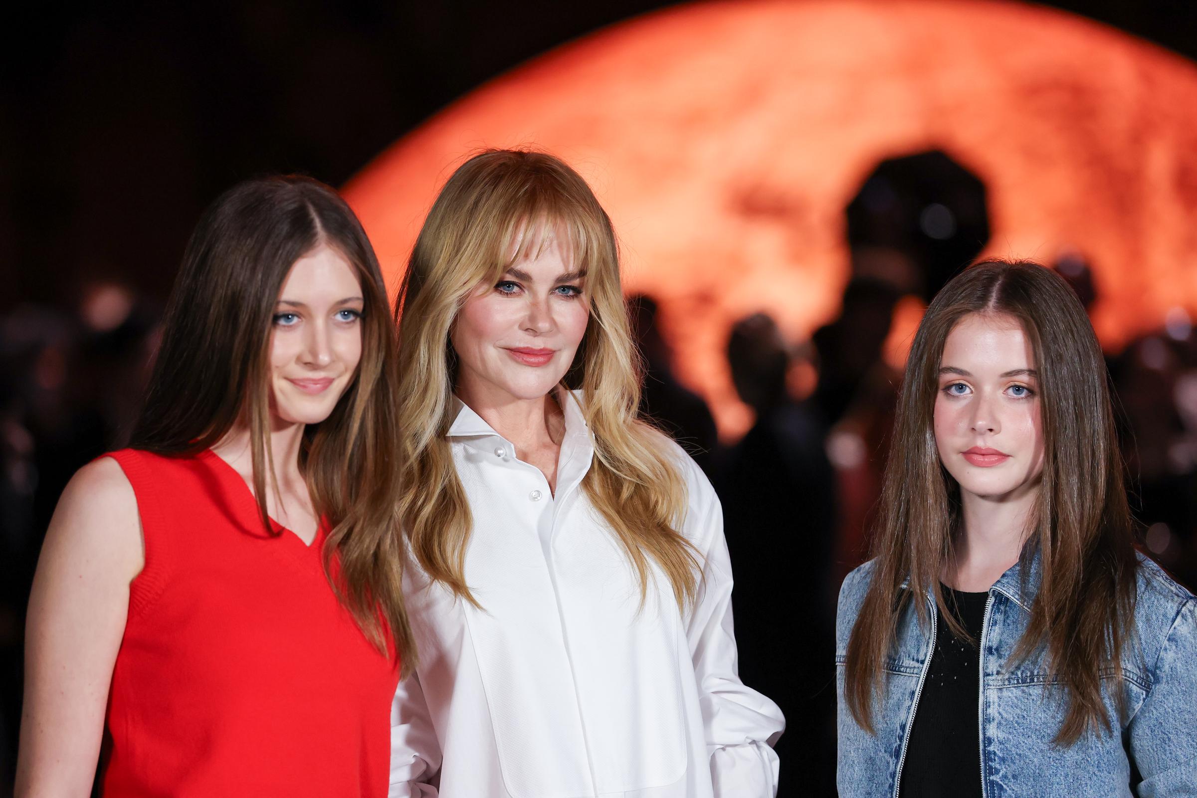 Nicole Kidman poses with daughters Sunday Rose (left) and Faith Margaret (right) at Chanel's Paris Fashion Week show in October 2025. Sunday made her runway debut for Miu Miu a year earlier, while Faith was still focused on school rather than modeling. | Source: Getty Images