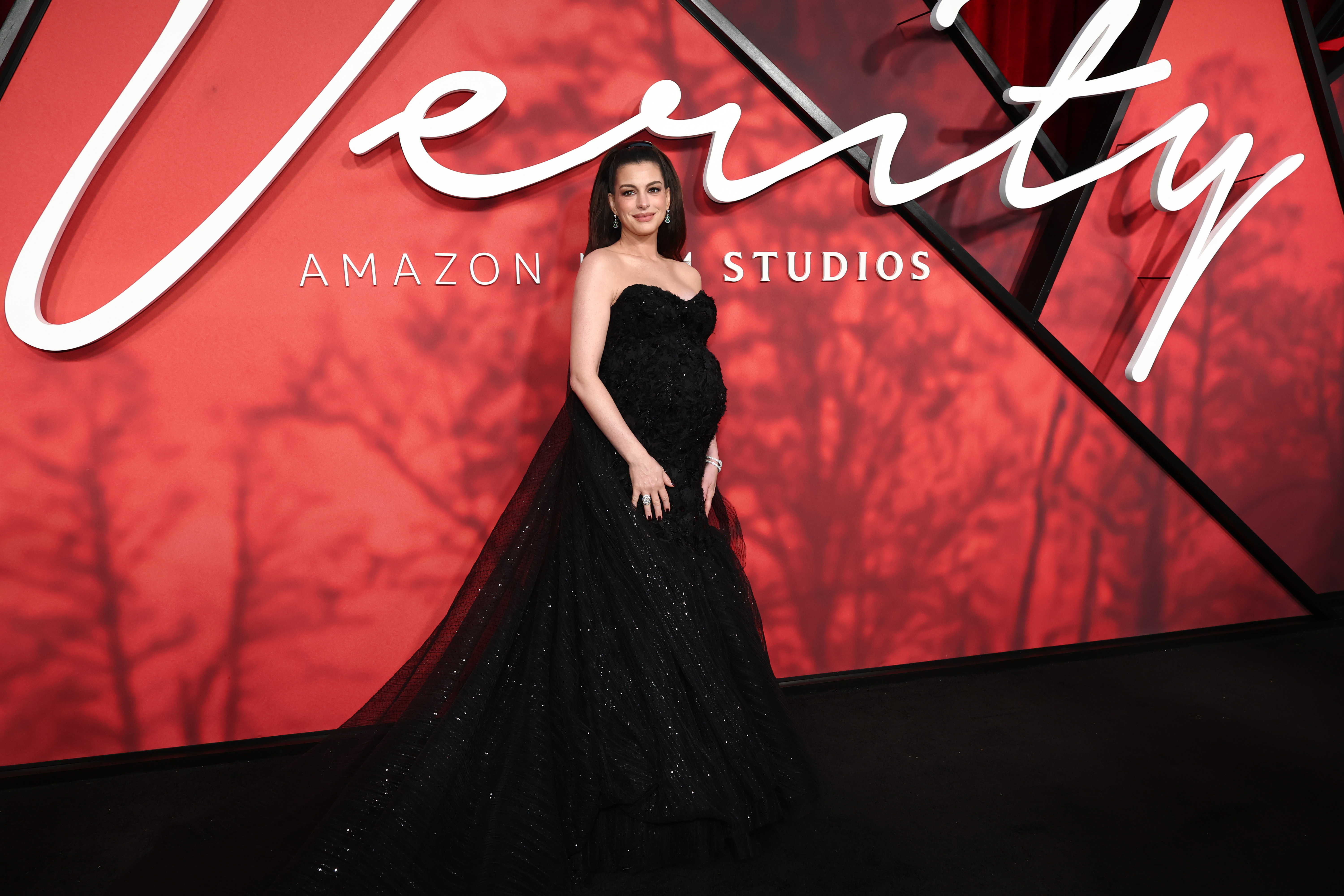 The black gown was custom-made by Atelier Prabal Gurung, giving Hathaway a couture look created specifically for this late stage of her pregnancy rather than adapting an off-the-rack silhouette. | Source: Getty Images