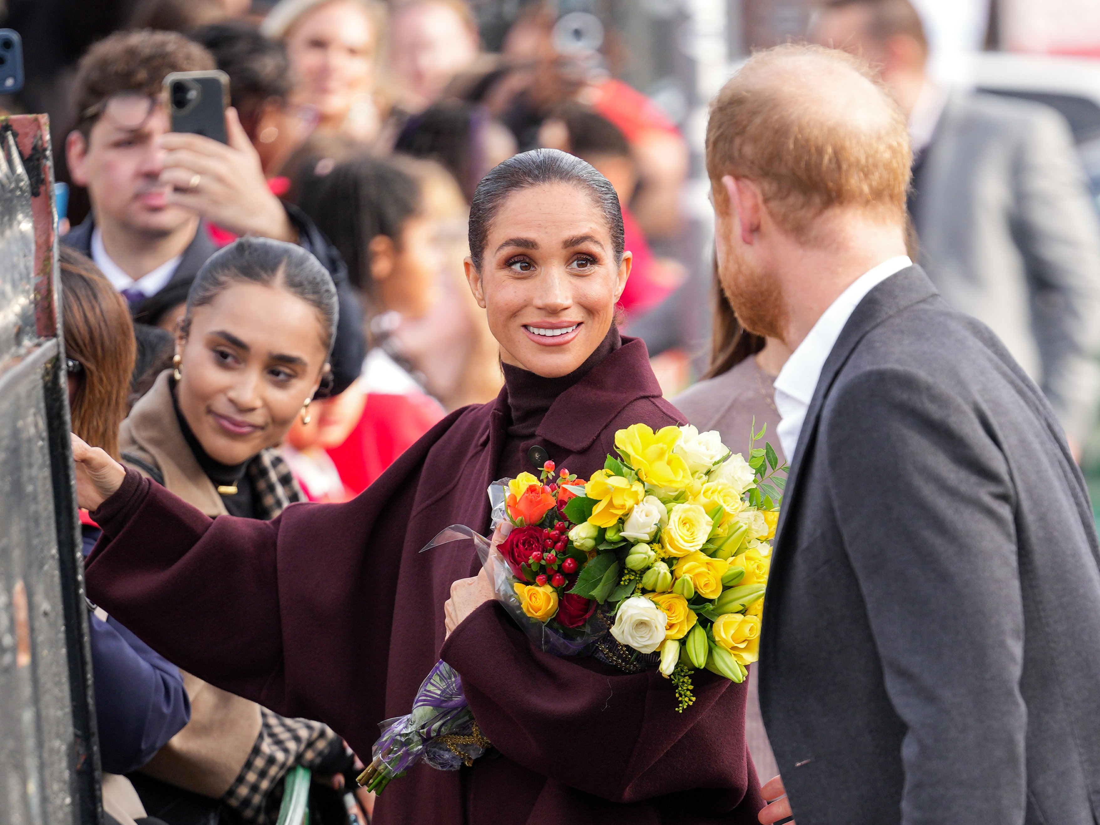Meghan, Duchess of Sussex holds a bouquet of flowers as she and Prince Harry, Duke of Sussex arrive at the Community Recording Studio (CRS). | Source: Getty Images