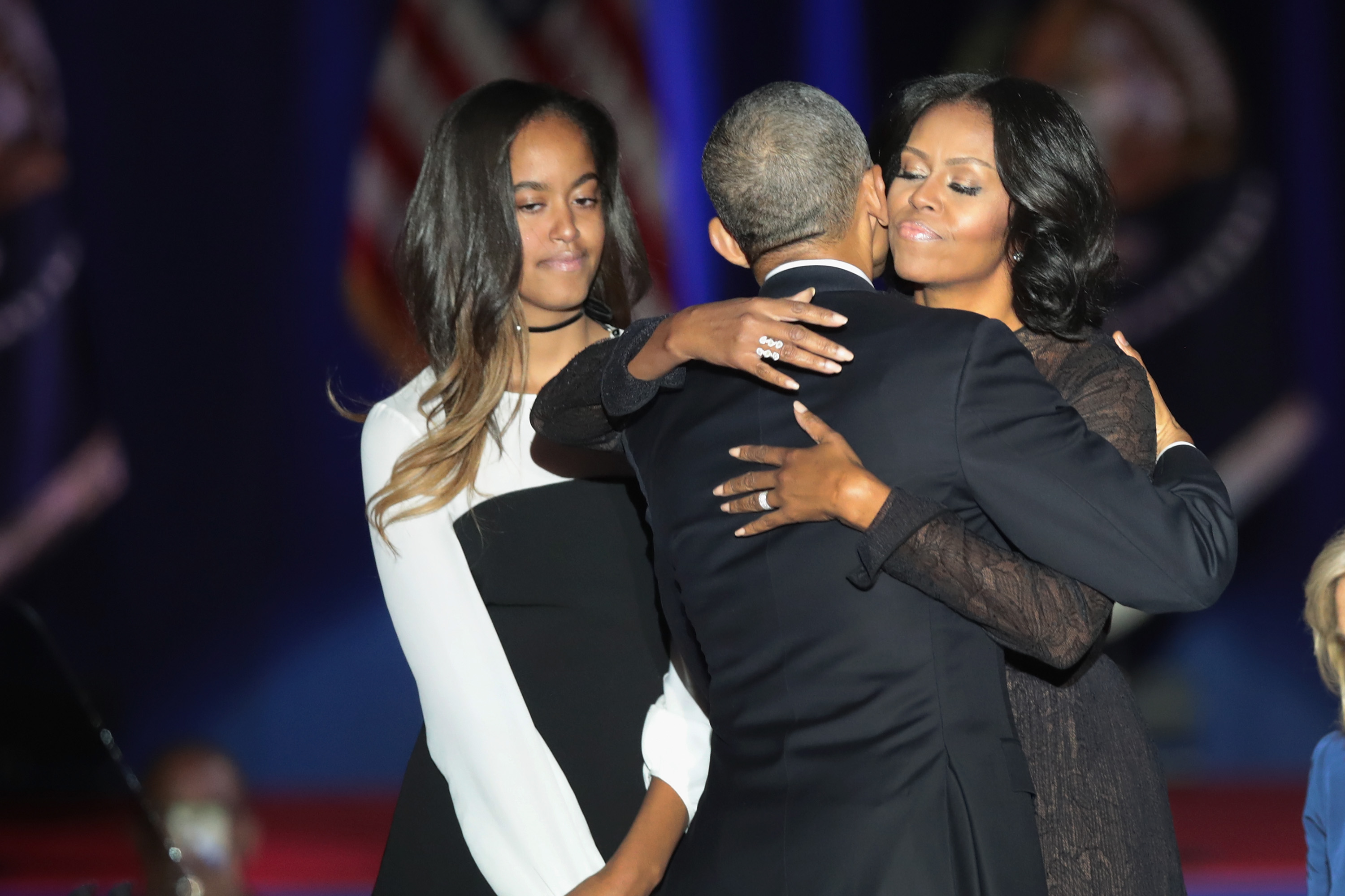 Barack embraced Michelle onstage after his January 10, 2017, farewell address in Chicago while their daughter Malia stood nearby. | Source: Getty Images