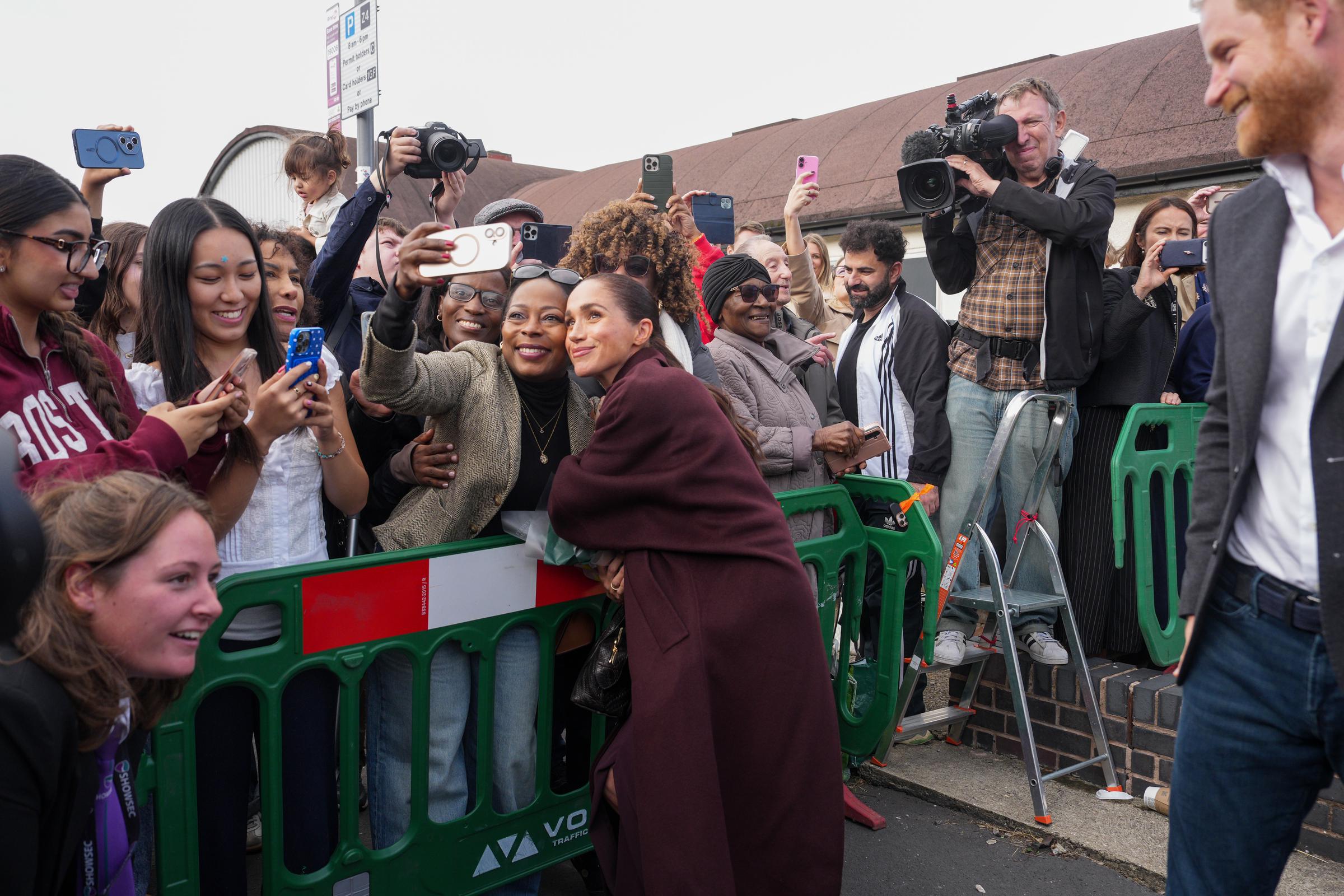 Meghan, Duchess of Sussex, and Prince Harry, Duke of Sussex, greet well-wishers as they leave the Community Recording Studio (CRS). | Source: Getty Images