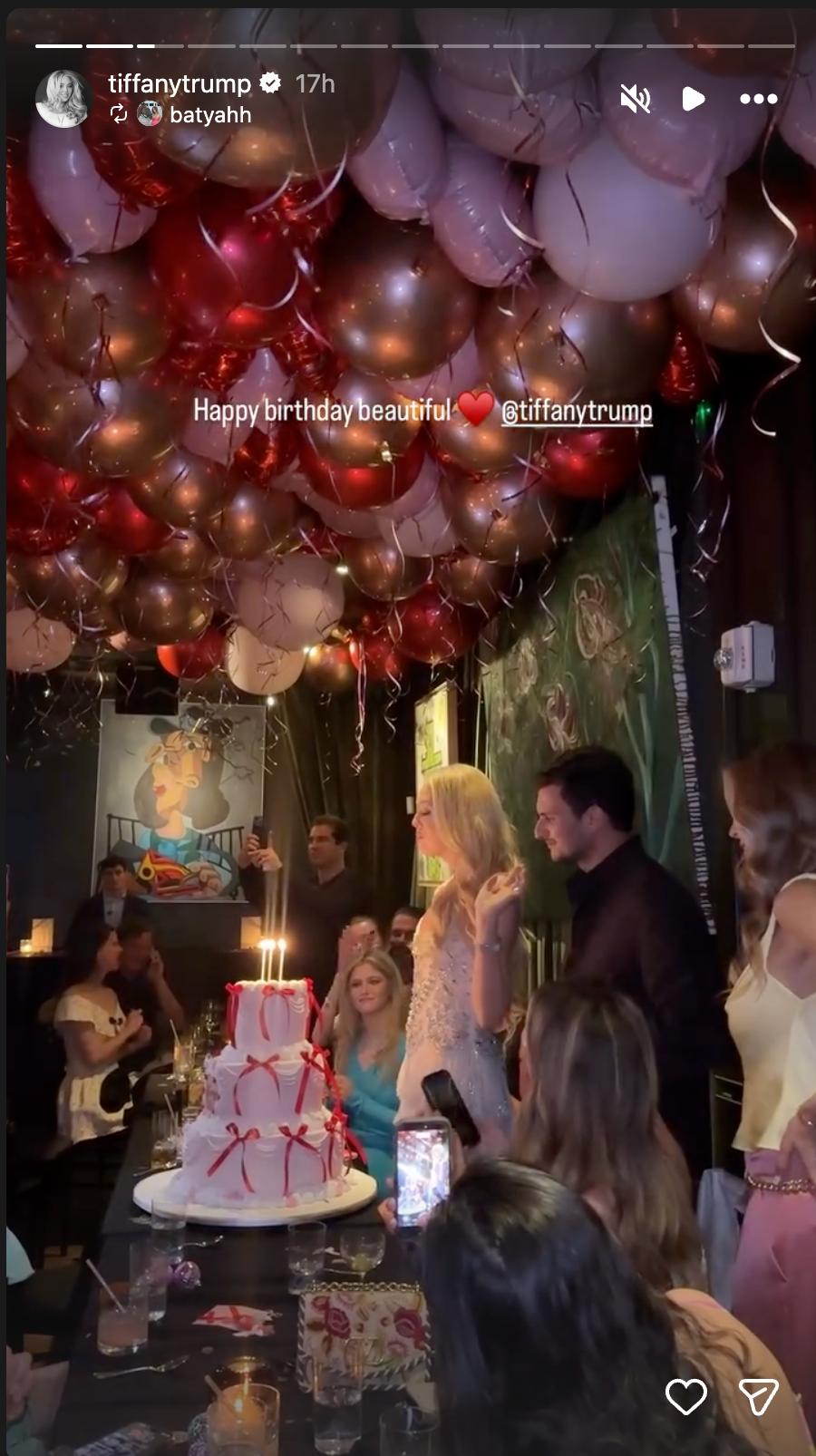 Tiffany Trump celebrated surrounded by loved ones beneath a ceiling of colorful balloons, with her elaborate birthday cake taking center stage. | Source: Instagram/tiffanytrump