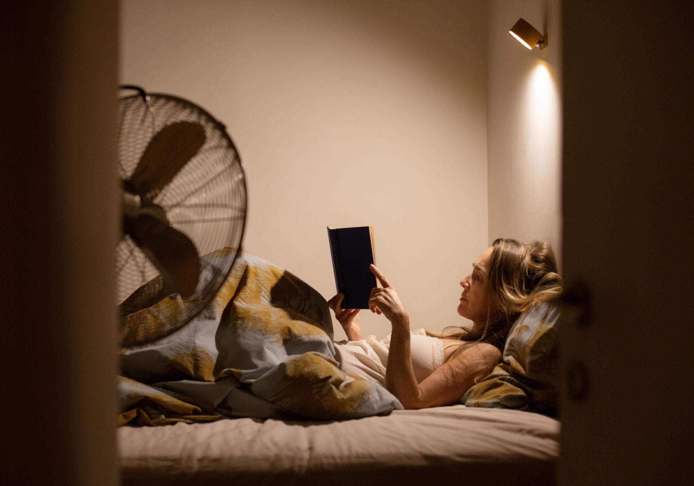 A woman reading a book at night | Source: Getty Images