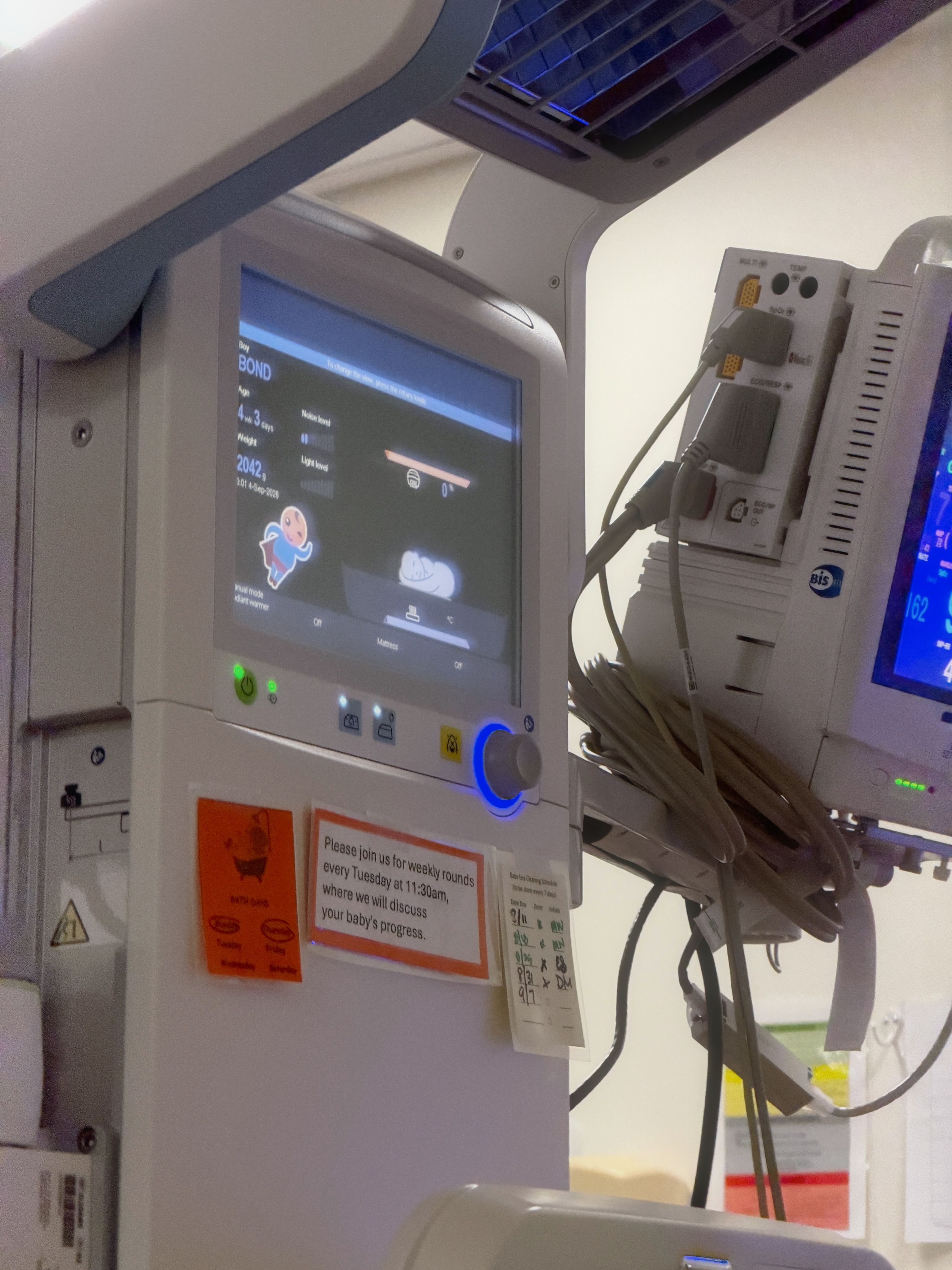 1. A hospital monitor displays Bond's name and weight amid the medical equipment used during the premature newborn's extended NICU stay. | Source: Instagram/elliottpbure