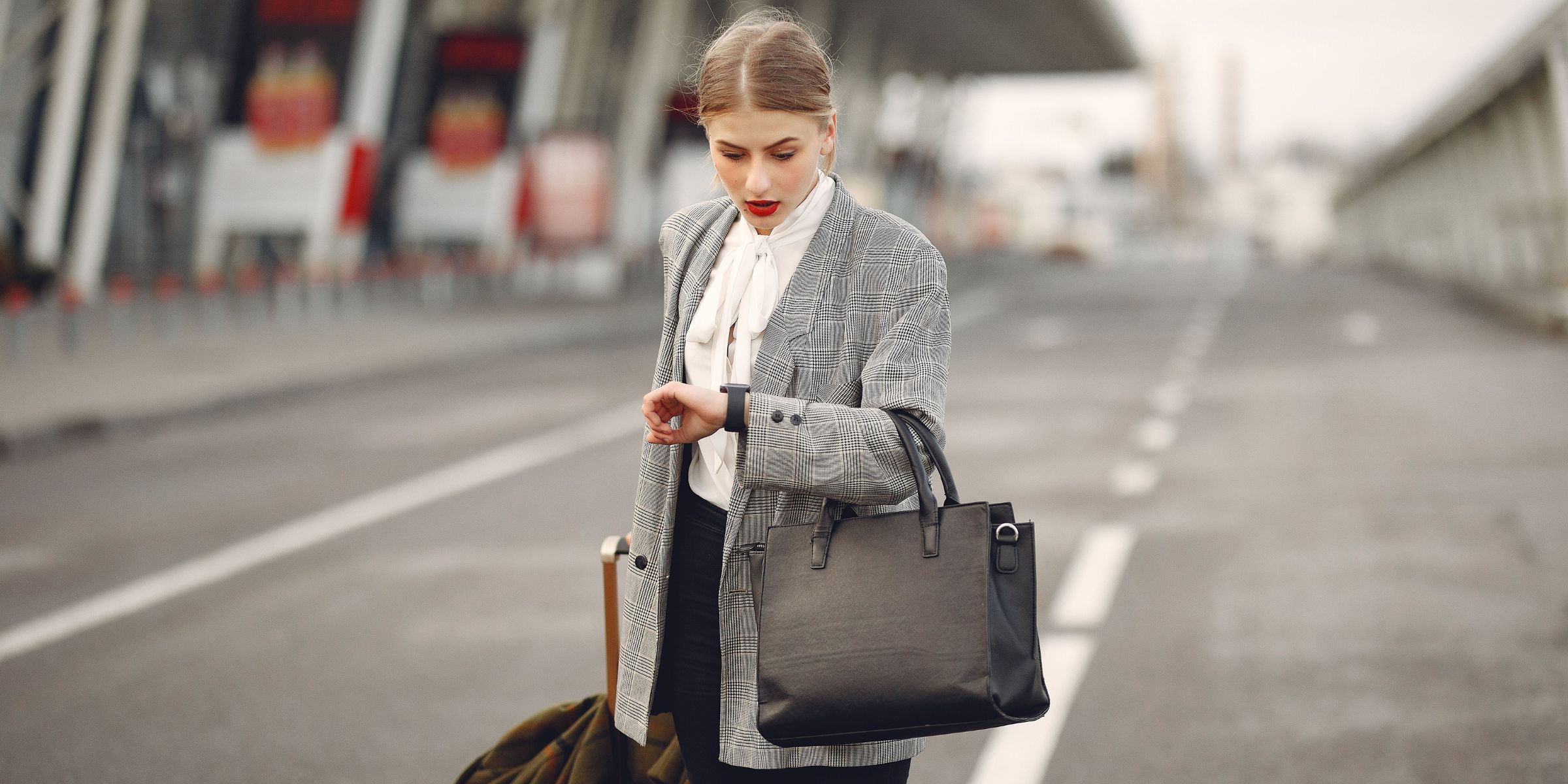 A woman looking at her watch at an airport terminal | Source: Pexels
