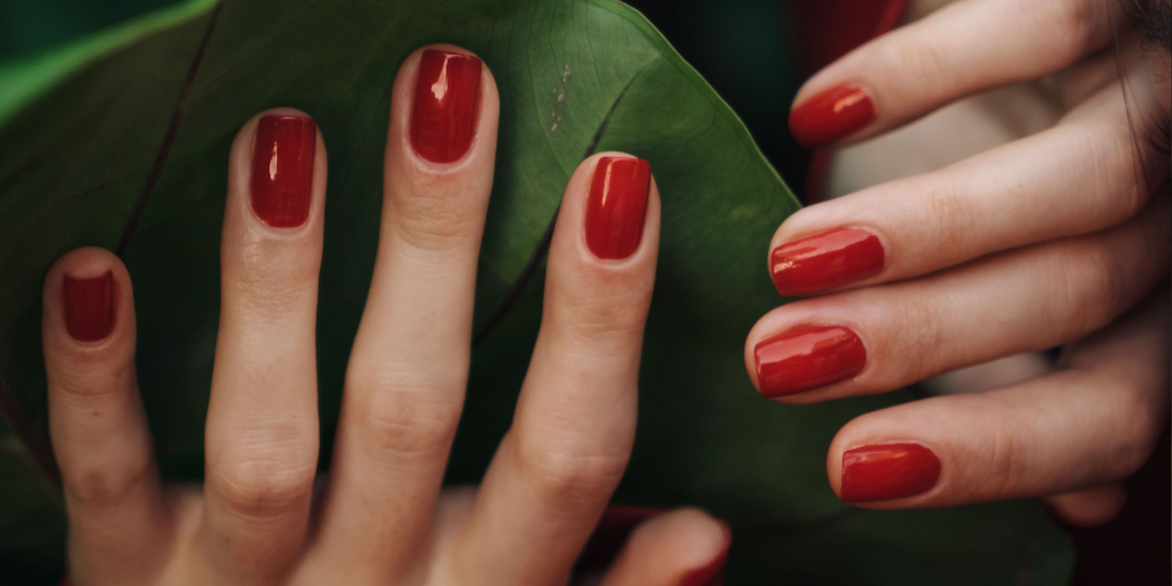 A pair of hands with red nail polish | Source: