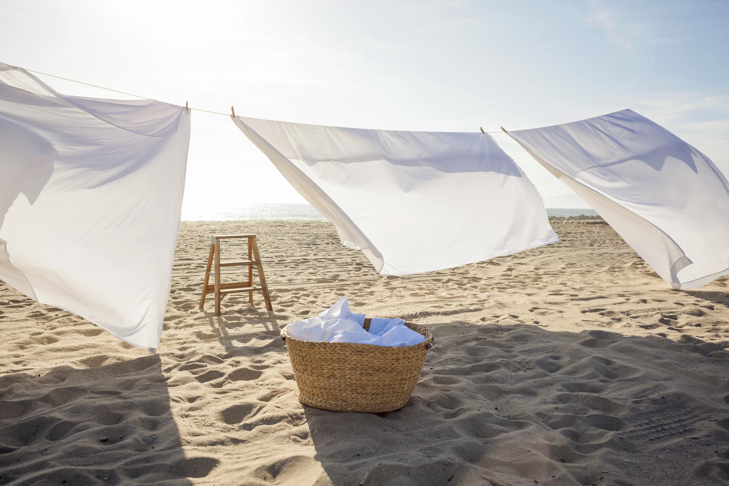 White Sheets hanging on laundry line at beach | Source: Getty Images
