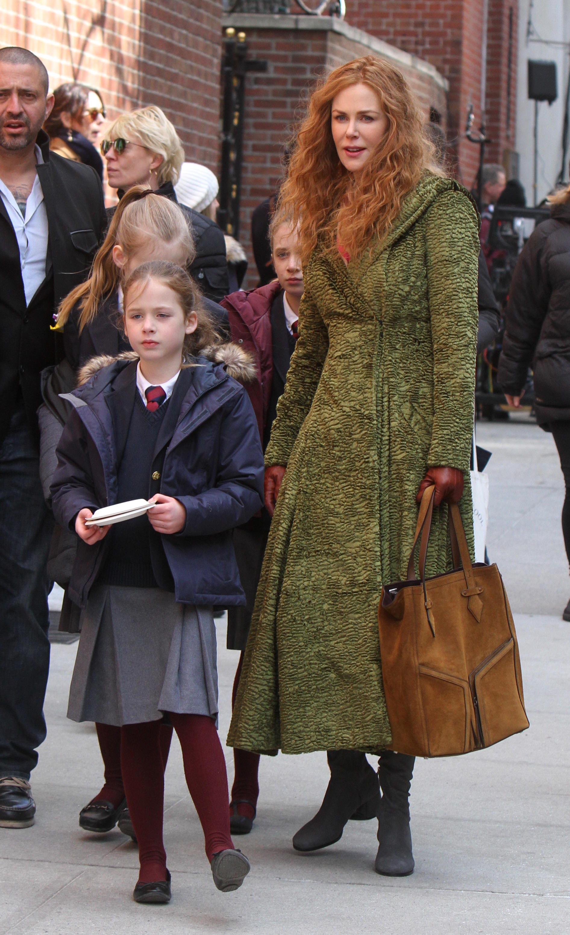 Nicole Kidman walks alongside her daughters, Sunday Rose and Faith Margaret, who are both dressed in school uniforms, in New York City in March 2019. | Source: Getty Images