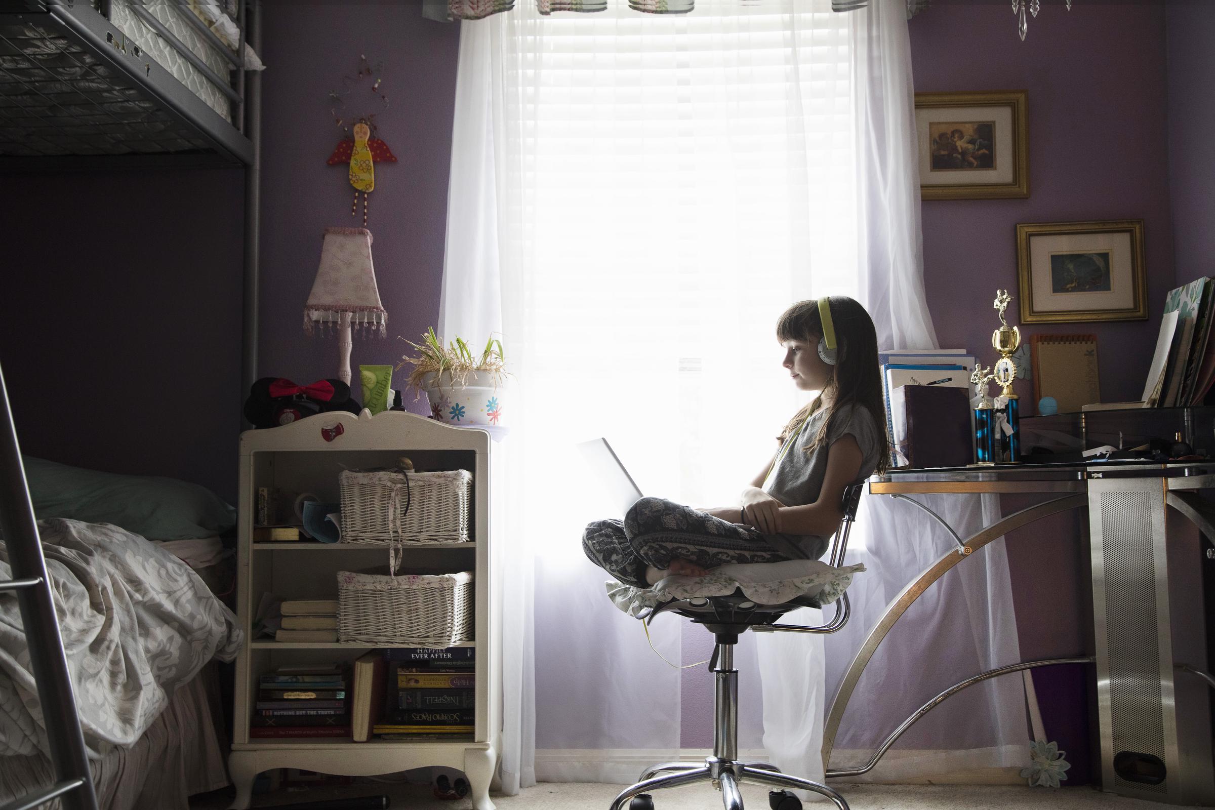A young girl studying alone in her room | Source: Getty Images