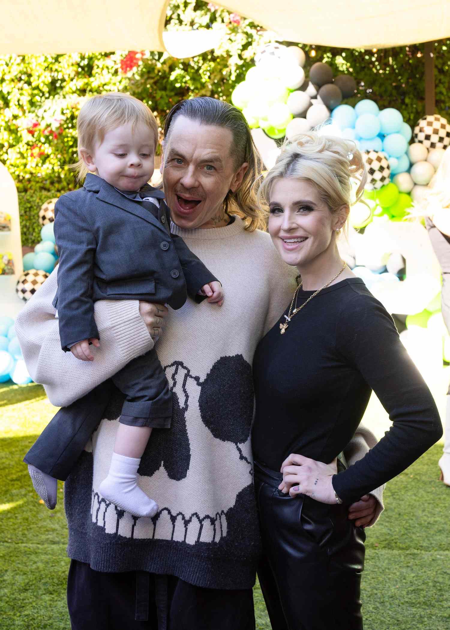 Kelly Osbourne and Sid Wilson shared a happy family moment with their son Sidney at an outdoor celebration, posing together before the couple's engagement came to an end. | Source: Getty Images