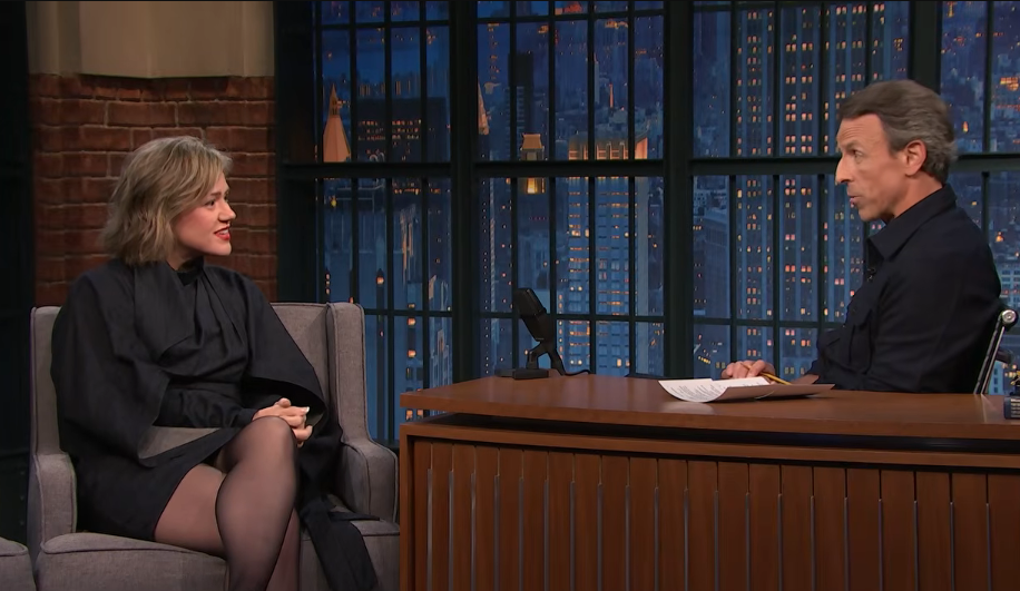 Kelly Clarkson listened intently while conversing with host Seth Meyers during her appearance on "Late Night with Seth Meyers" on September 21, 2026, showcasing her chic, chin-grazing bob haircut with side-swept fringe, paired elegantly with an all-black structured long-sleeve dress and sheer tights. | Source: YouTube/Late Night with Seth Meyers