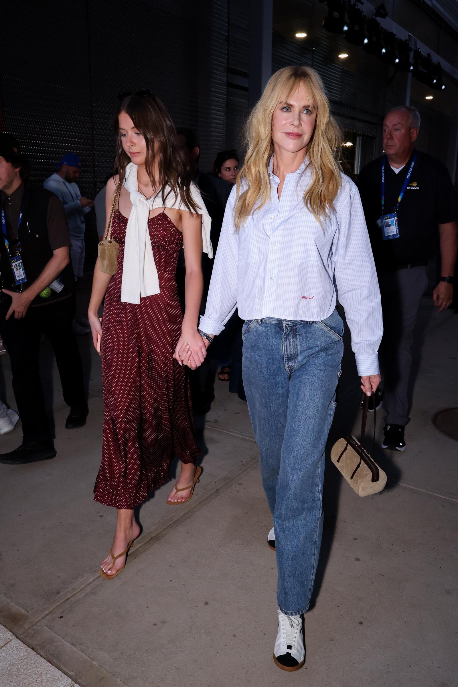 Nicole Kidman holds hands with her 15-year-old daughter, Faith Margaret, at the US Open in New York in September 2026. The pair opted for casual outfits, with Faith wearing a burgundy dress and Nicole choosing jeans and a striped shirt. | Source: Getty Images