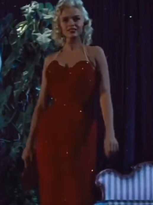 Mansfield commands the frame in "The Girl Can't Help It," displaying the tight column skirt and structured mid-century silhouette. | Source: TikTok/@neciashairstyling