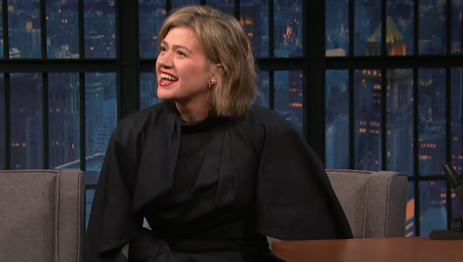 Kelly Clarkson laughed warmly while chatting on "Late Night with Seth Meyers" on September 21, 2026, showing off her chic, freshly cut dirty-blonde bob with side-parted volume that beautifully framed her face as she wore an elegant high-neck black dress. | Source: YouTube/Late Night with Seth Meyers