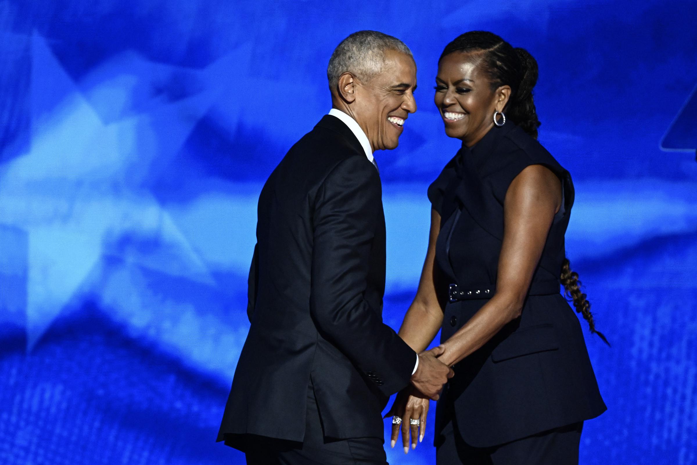 This August 2024 Getty frame captures Barack greeting Michelle onstage during the second night of the Democratic National Convention in Chicago. | Source: Getty Images