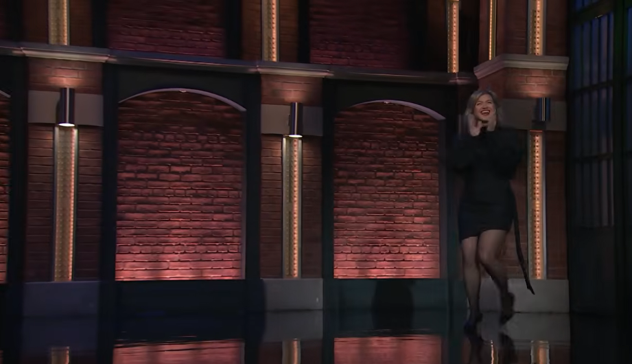 Making an energetic entrance onto the set of "Late Night with Seth Meyers" on September 21, 2026, Kelly Clarkson beamed as she debuted her voluminous new bob hairstyle, looking radiant in a structured black minidress and heels. | Source: YouTube/Late Night with Seth Meyers