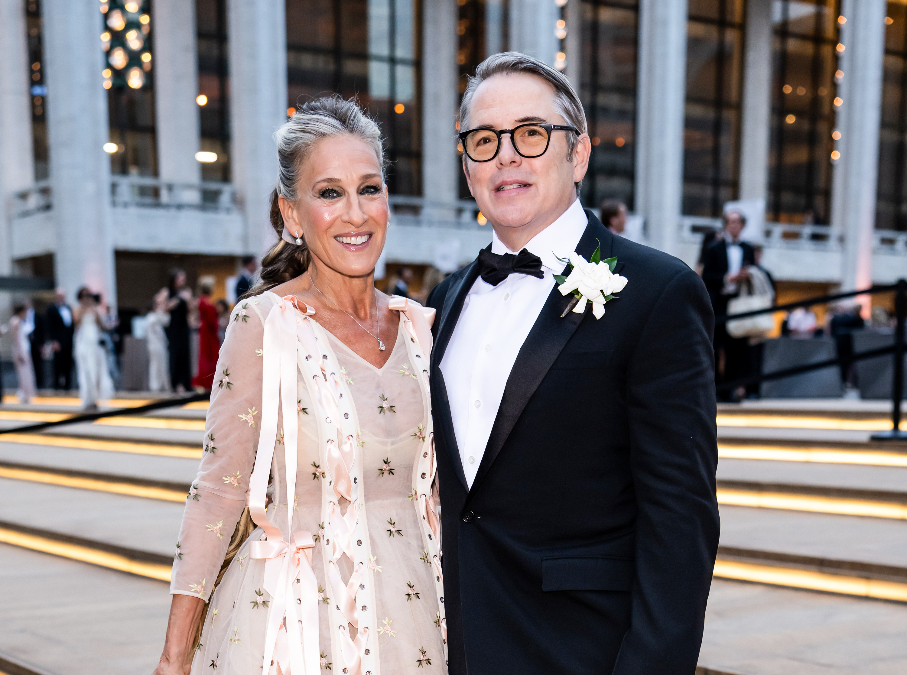 A closer look captures the tiny floral embroidery and satin ribbon detailing across Parker's gown as she and Broderick pose together during their ballet date night. | Source: Getty Images