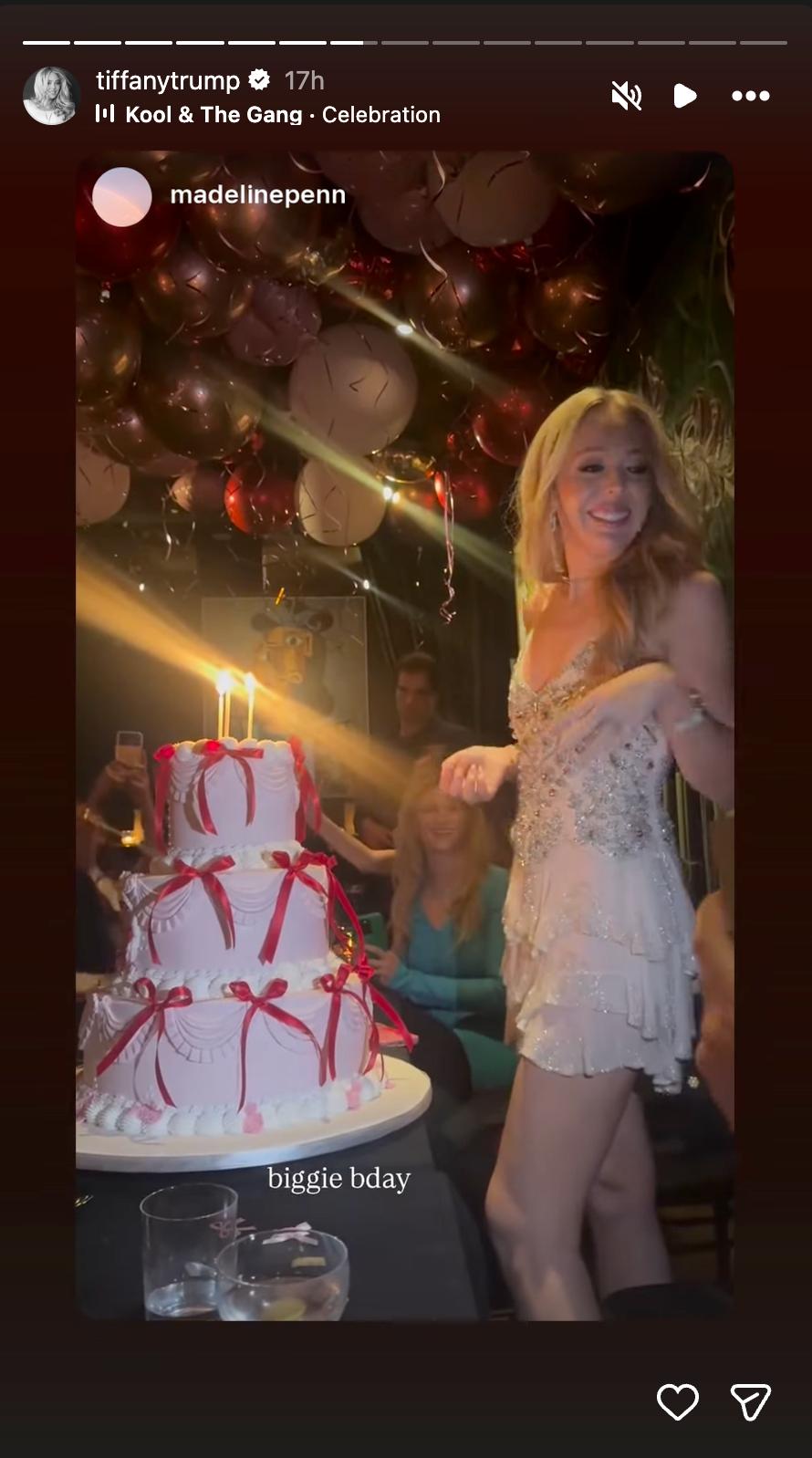 Tiffany smiled beside her towering birthday cake as guests captured the festivities, with red ribbons and glowing lights adding to the celebratory scene. | Source: Instagram/tiffanytrump
